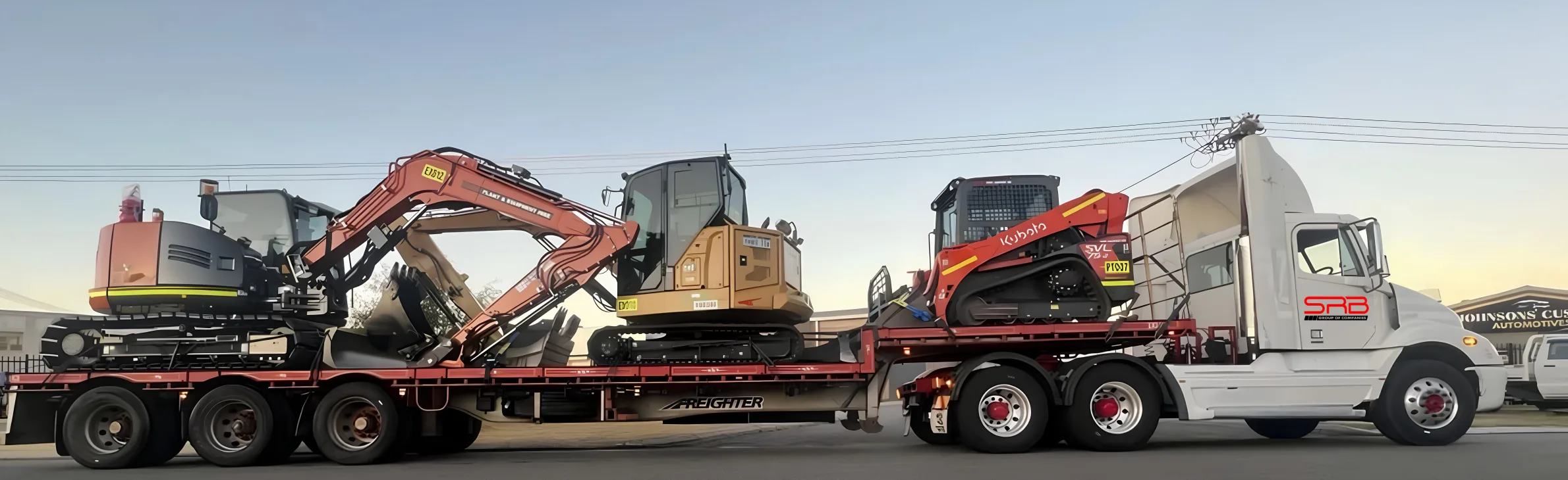 SRB prime mover hauling two excavators and a positrack on a low loader