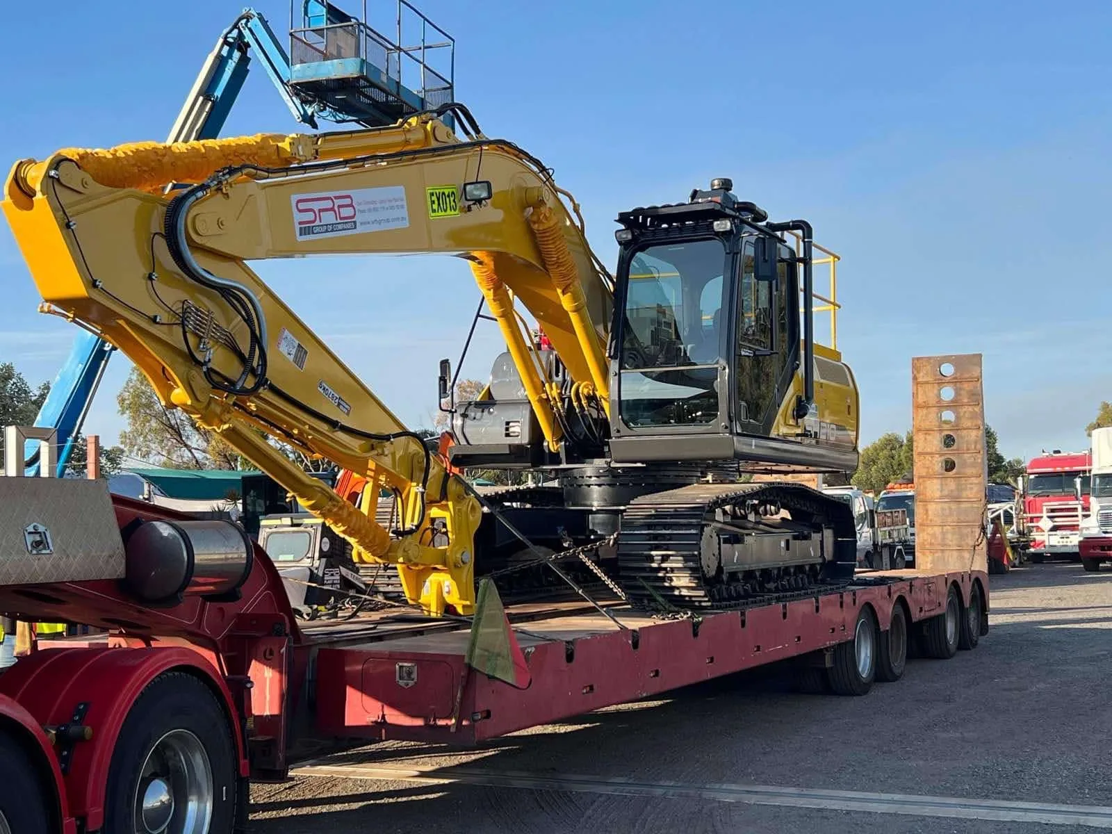 New Sumitomo excavator chained down on an SRB low loader
